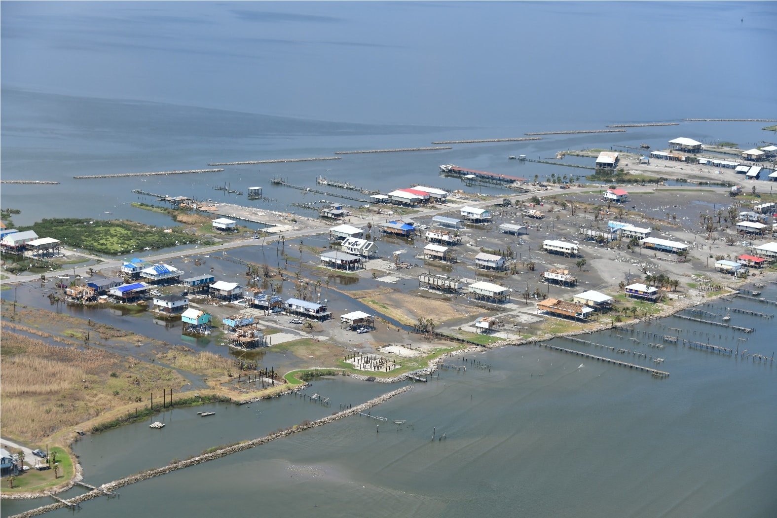 Wide aerial of a coastal Louisiana community flooded and damaged after Hurricane Ida